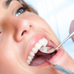 Extreme close up of beautiful young girl having dental check up.